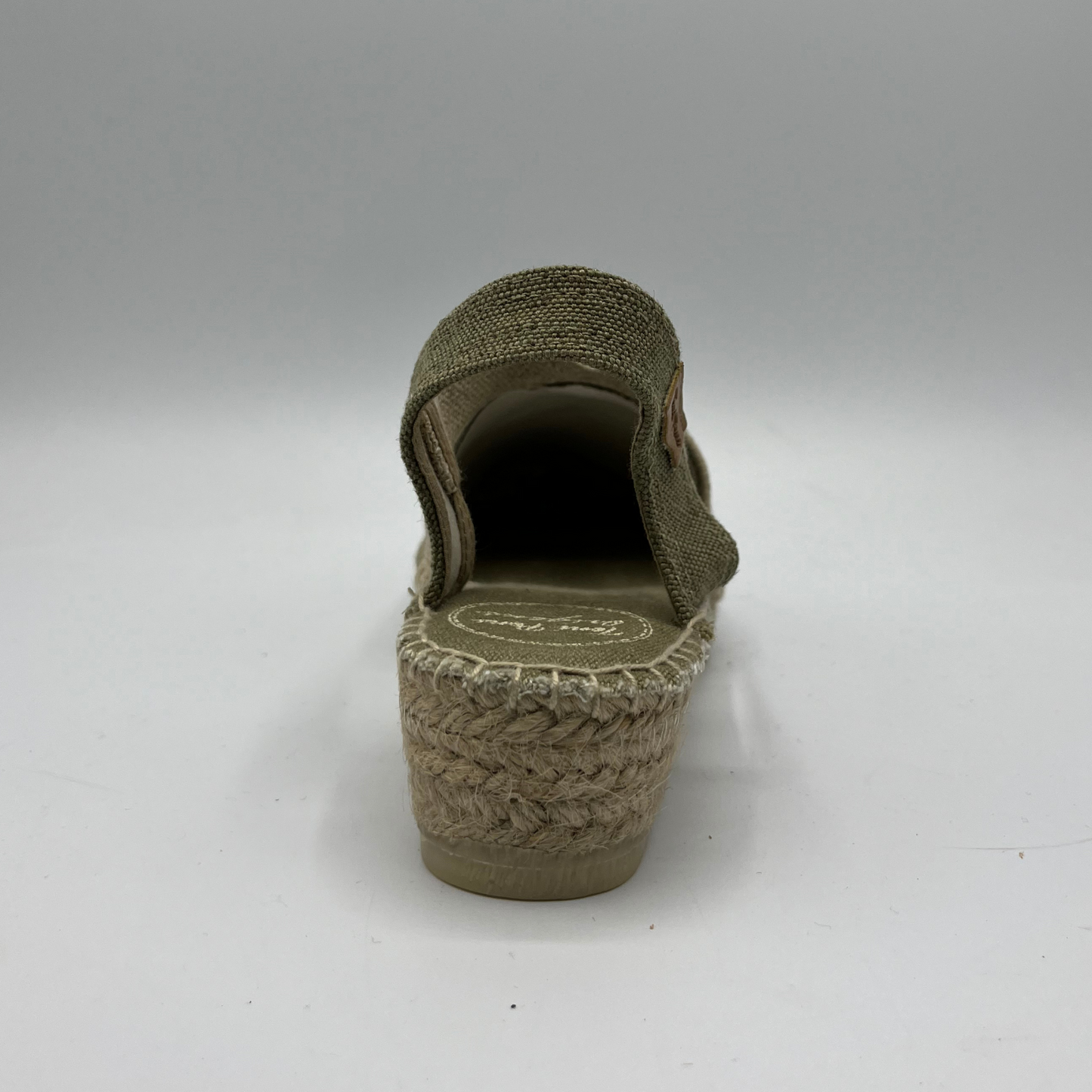 Back view of a canvas and textile espadrille with a low platform sole.