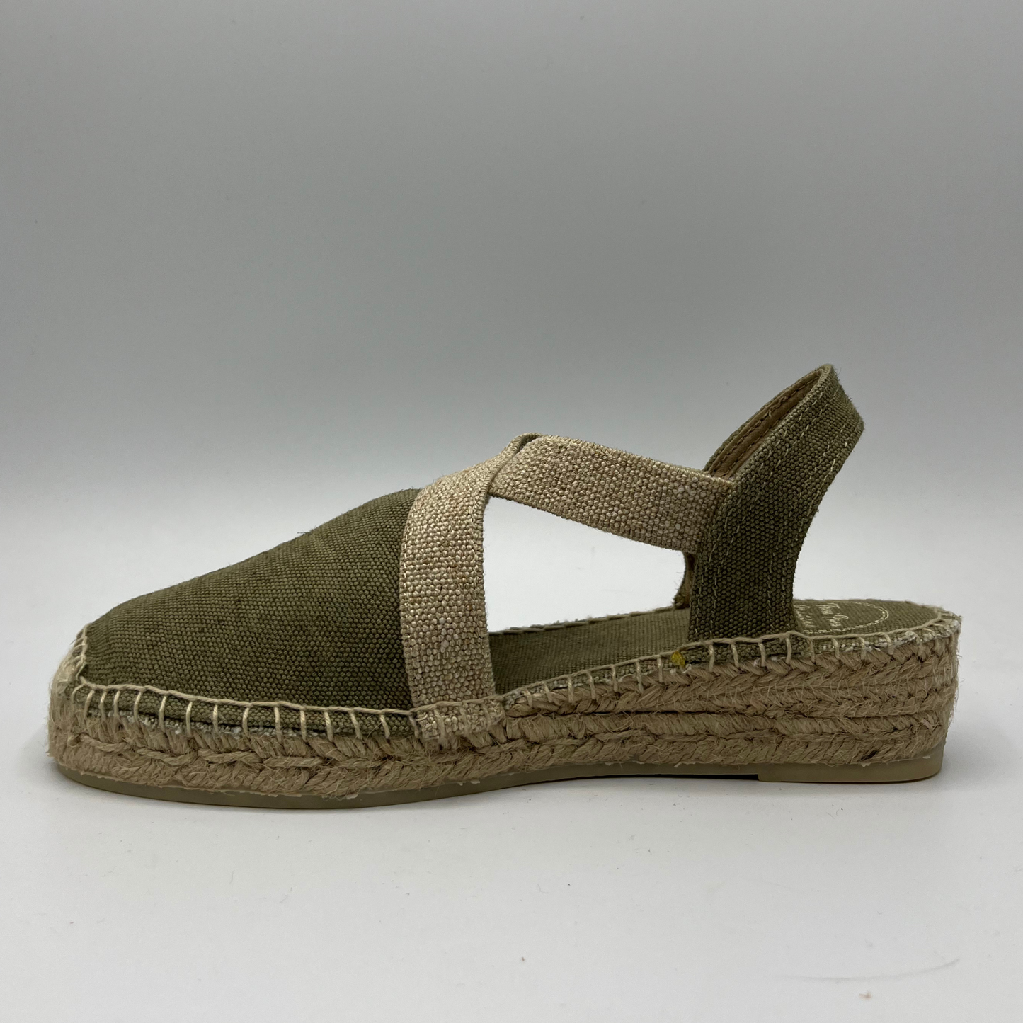 Left facing view of a canvas and textile espadrille with a low platform sole.