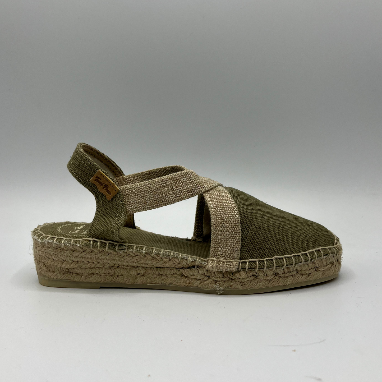 Right facing view of a canvas and textile espadrille with a low platform sole.