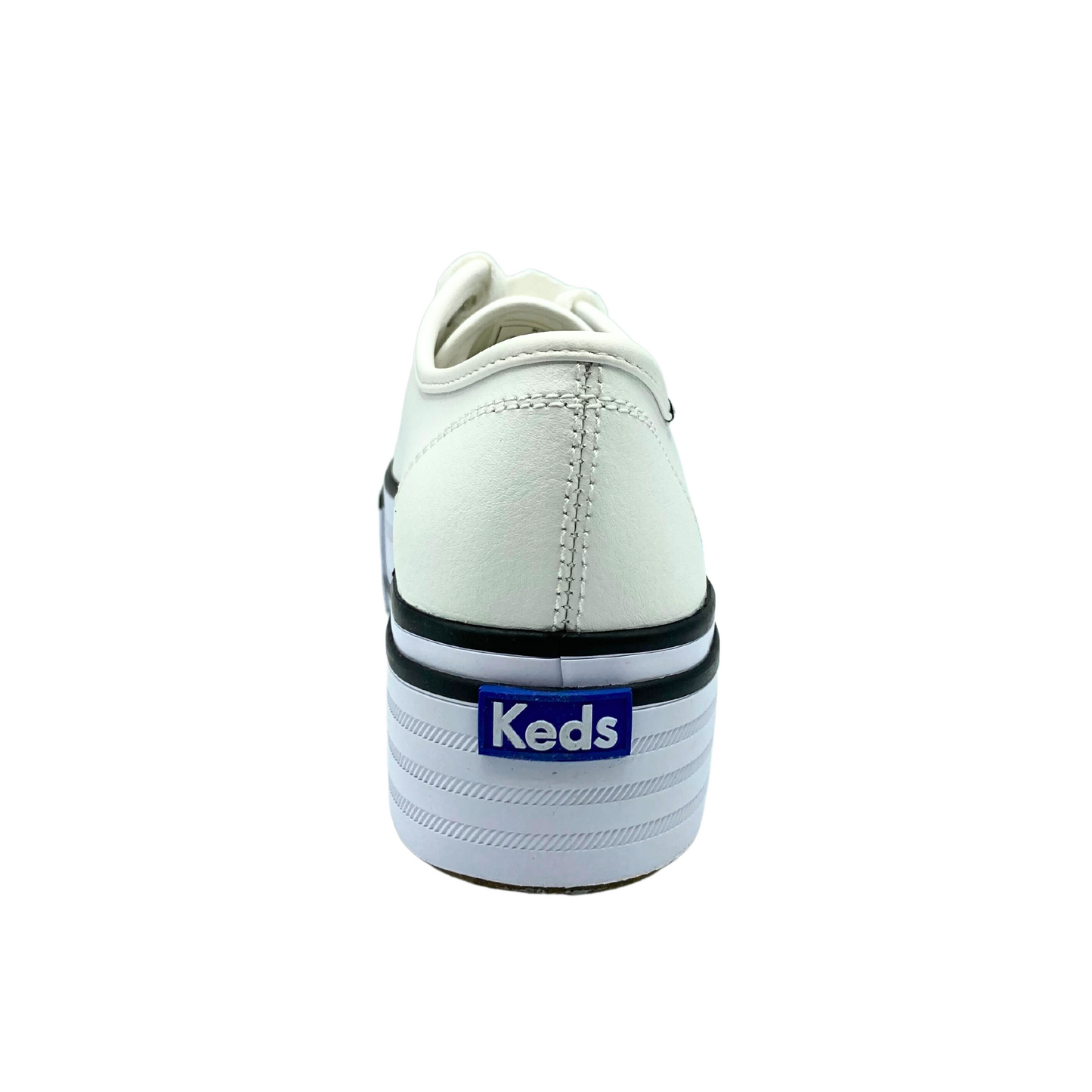 Rear view of a white leather sneaker on a platform sole. Keds logo on outsole at the heel. Dark stripes on outsole for contrast