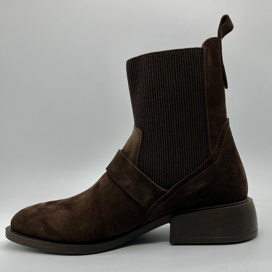 Brown ankle boot with suede finish on a gray background