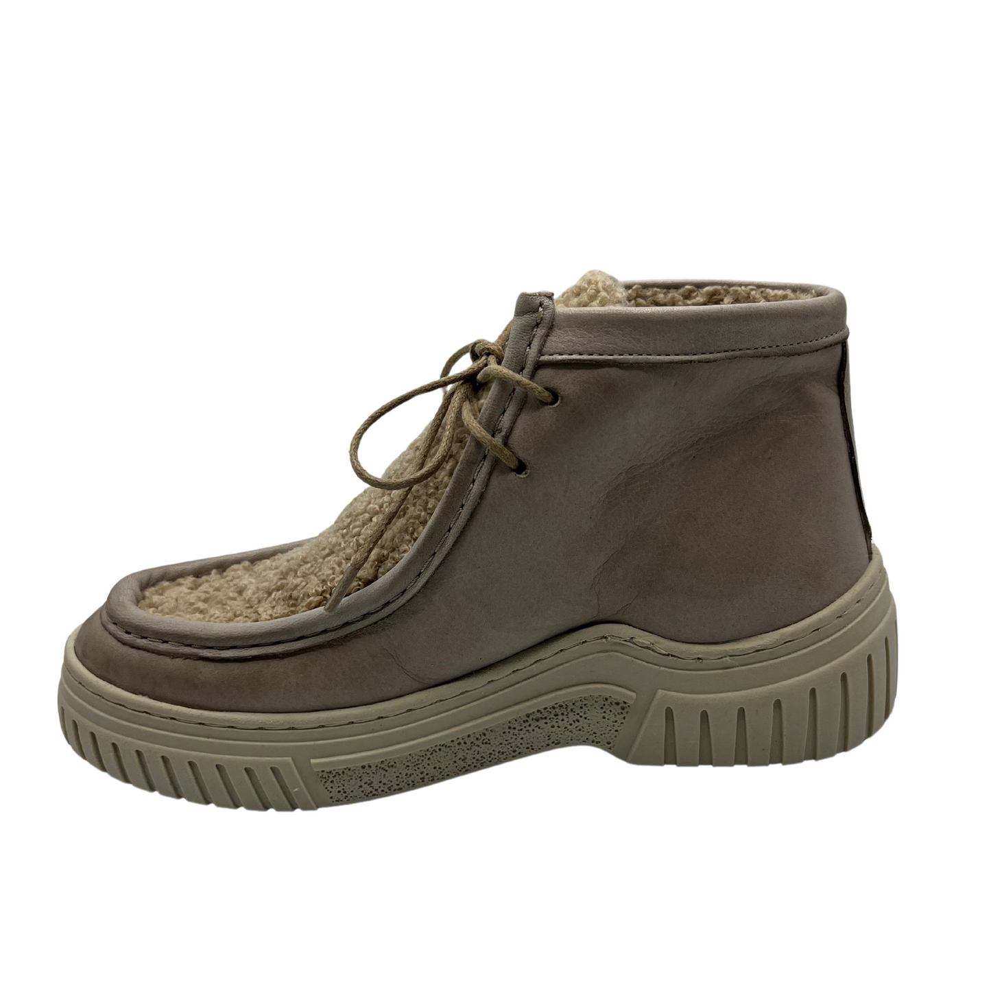 Left facing view of leather and sherpa ankle boot with thin laces and thick cream coloured outsole