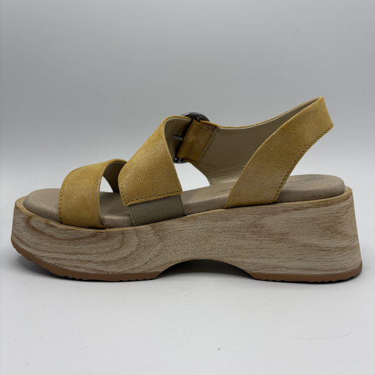 Yellow sandal with wooden sole on a white background