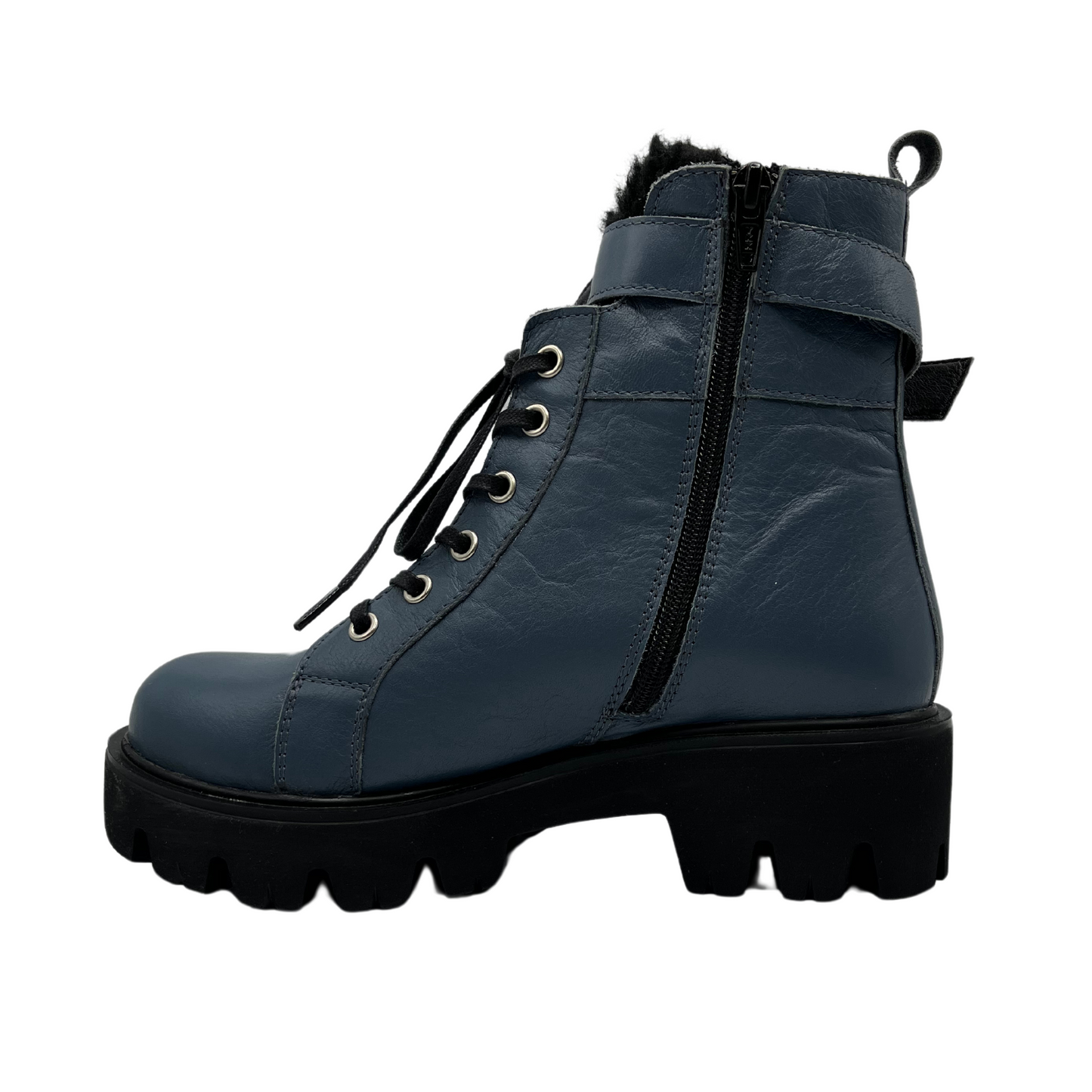 Left facing view of sky blue leather boot with silver buckle on the ankle strap. black lug sole and side zipper closure.