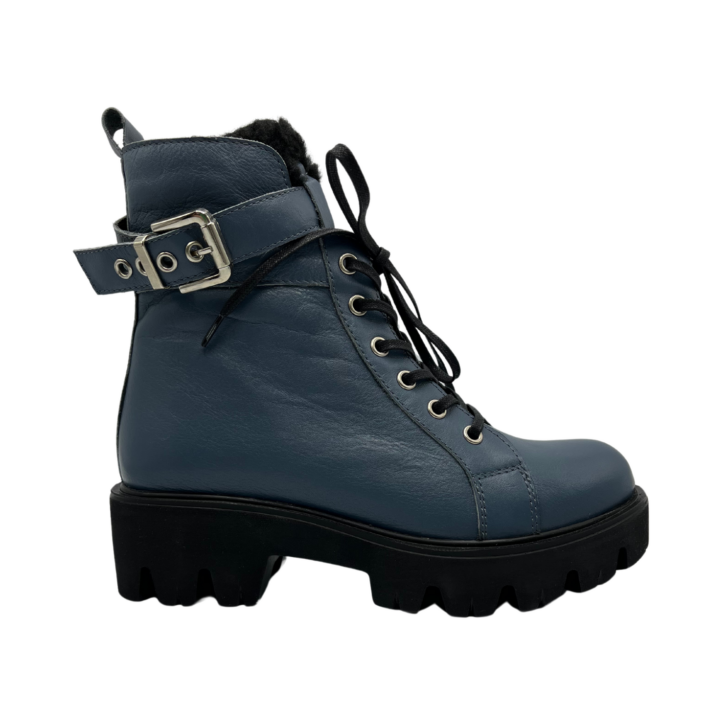 Right facing view of sky blue leather boot with silver buckle on the ankle strap. black lug sole and side zipper closure.