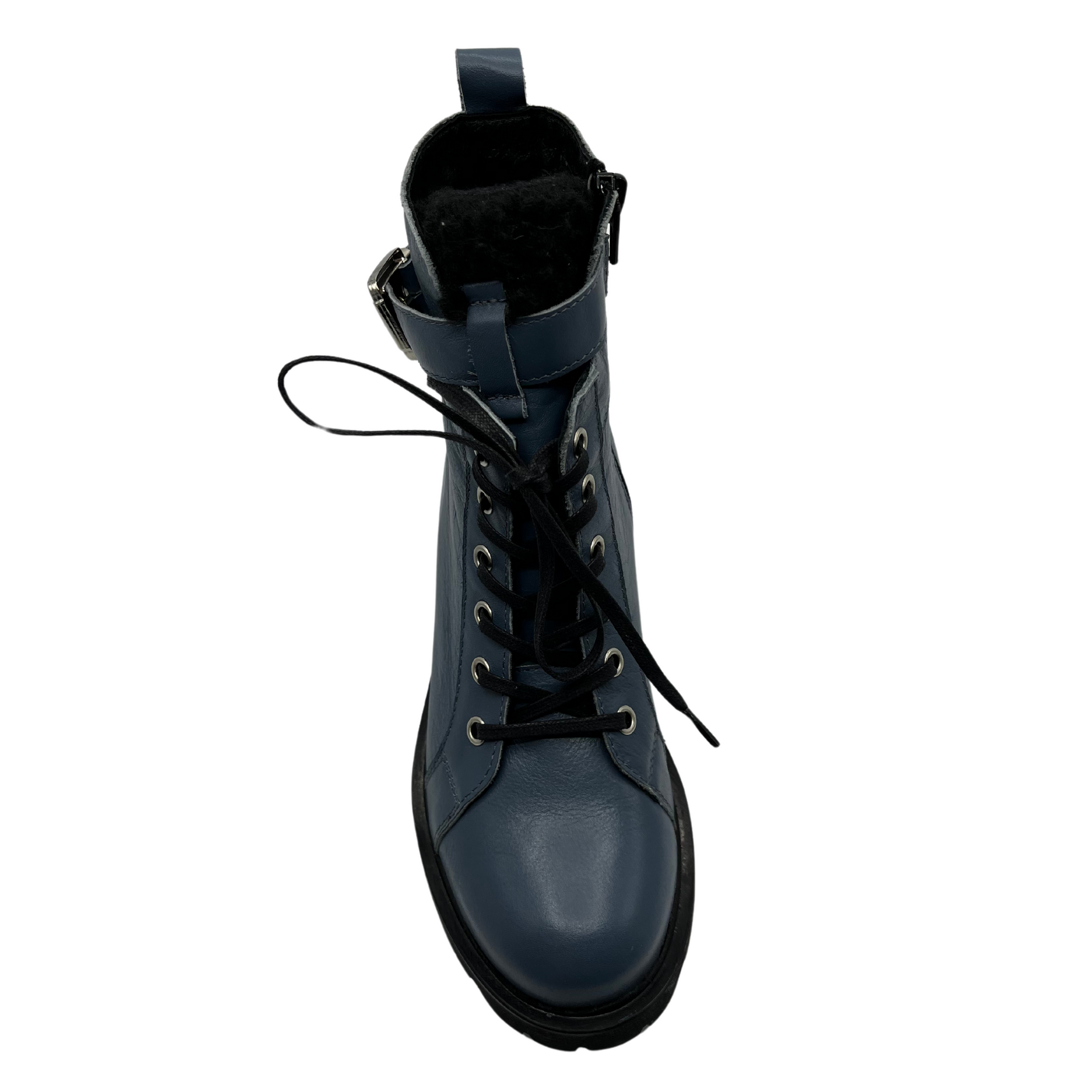 Top view of sky blue leather boot with silver buckle on the ankle strap. black lug sole and side zipper closure.