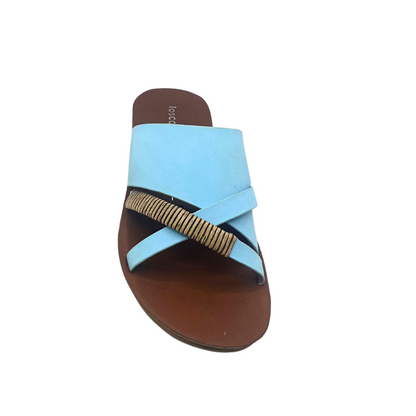 Top down view of a slip on sandal in a chalk blue leather with a metallic detail on one of the straps.