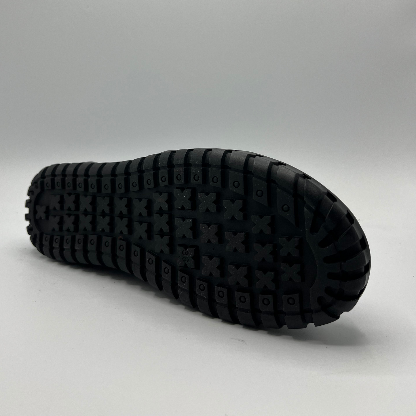 Black sole of a shoe on a gray background