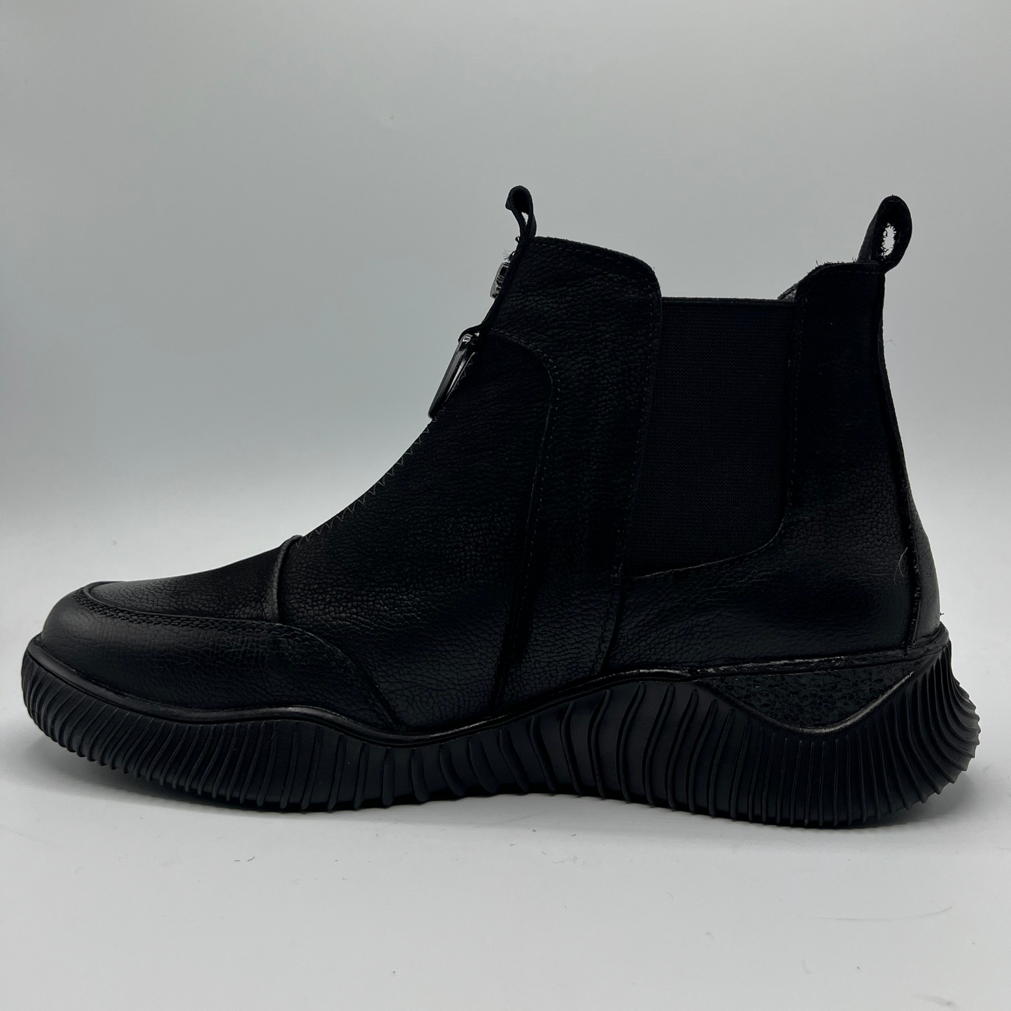 Black ankle boot on a light gray background