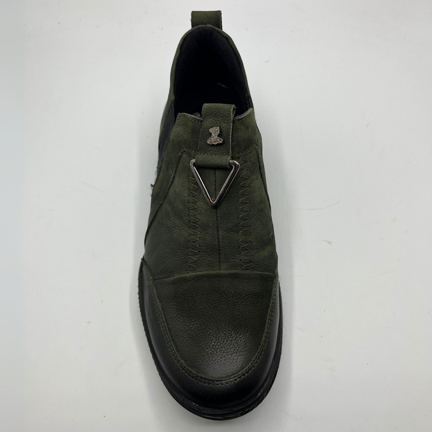 Green leather shoe on a white background