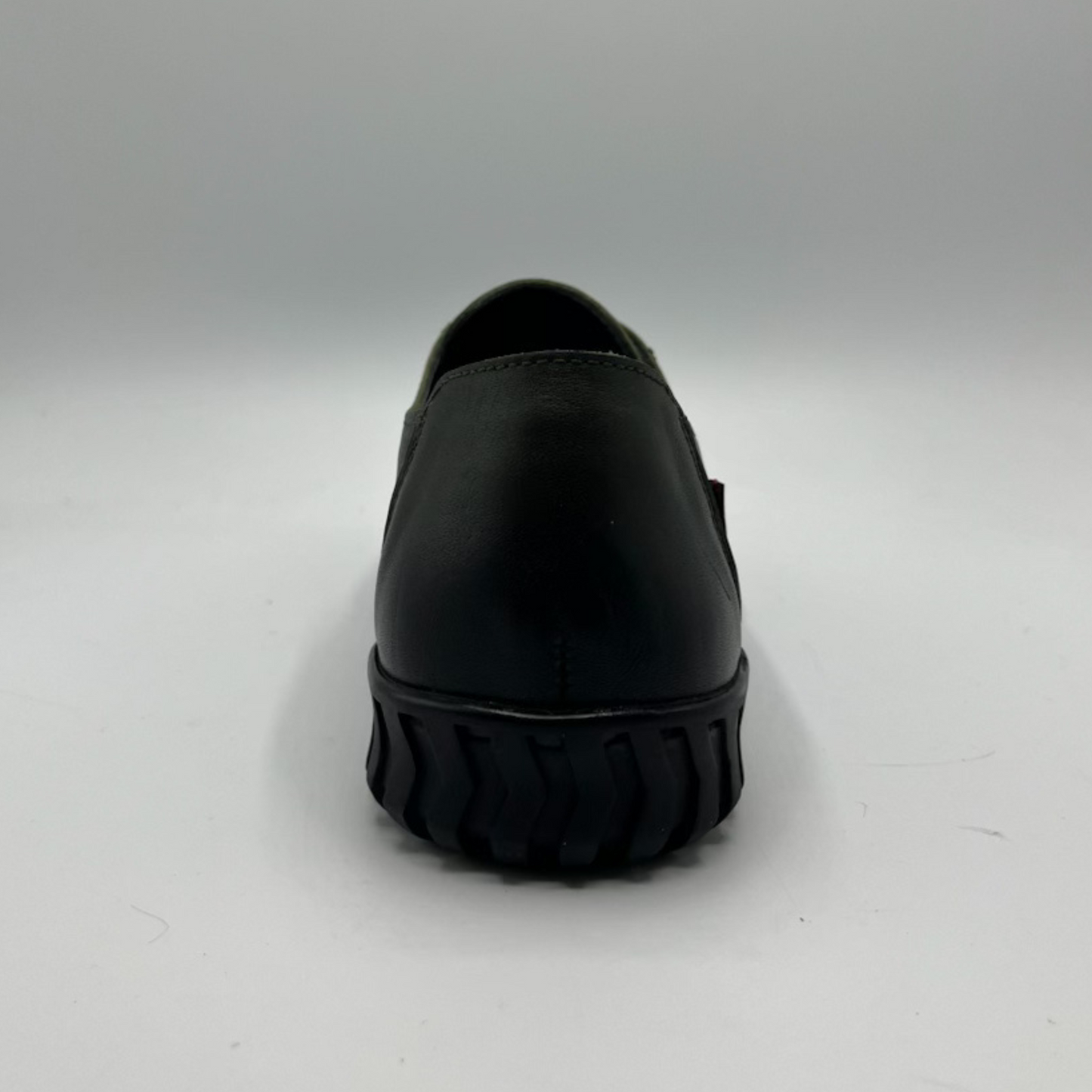 Olive slip-on shoe on a gray background