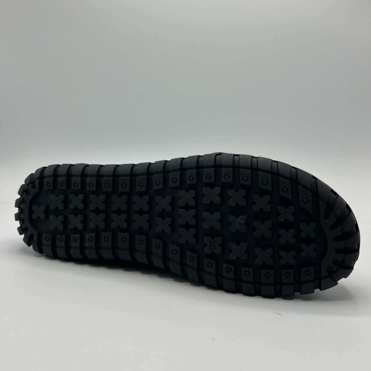 Black sole of a shoe on a gray background