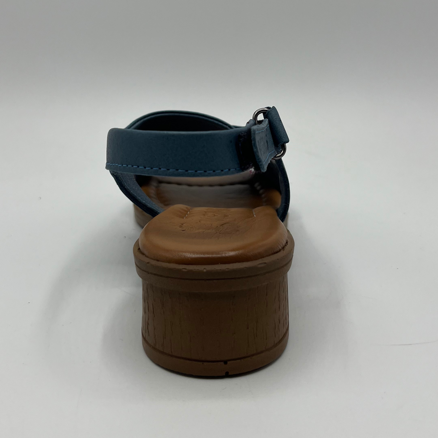 Back view of a blue cross strapped sandal with an adjustable slingback strap with a short heel.