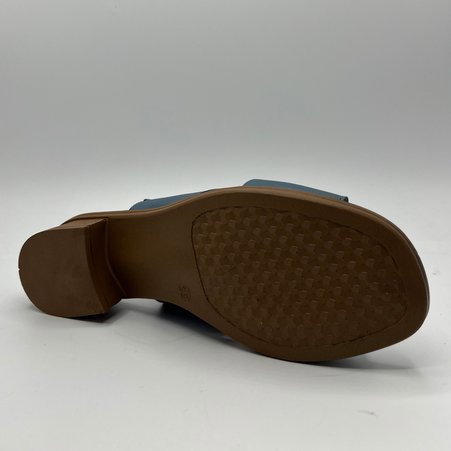 Bottom view of a blue cross strapped sandal with an adjustable slingback strap with a short heel.