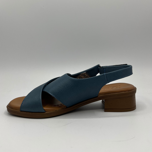 Left facing view of a blue cross strapped sandal with an adjustable slingback strap with a short heel.