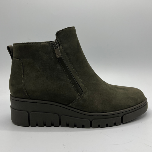 Green ankle boot with a zipper on a white background