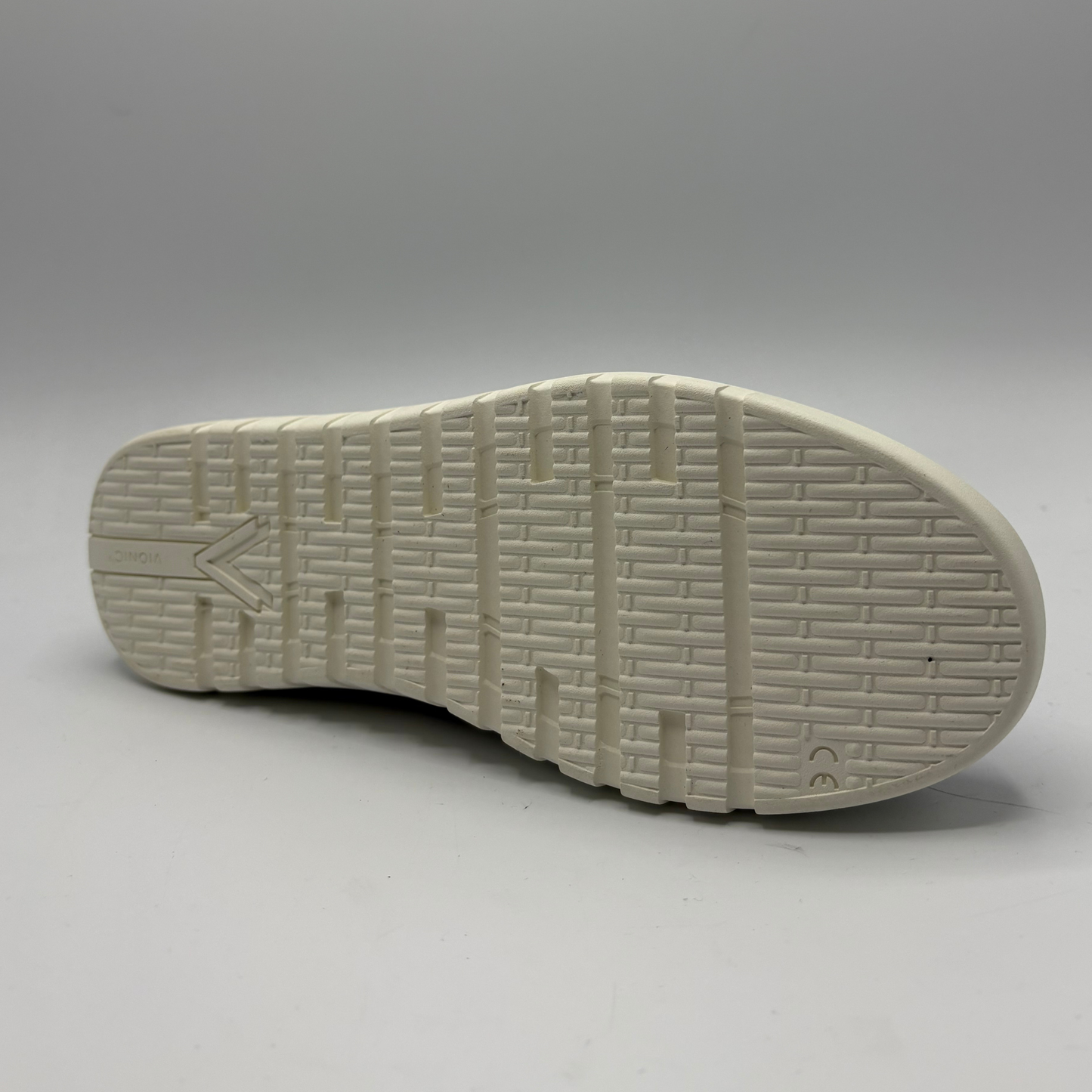 White sole of a shoe on a gray background