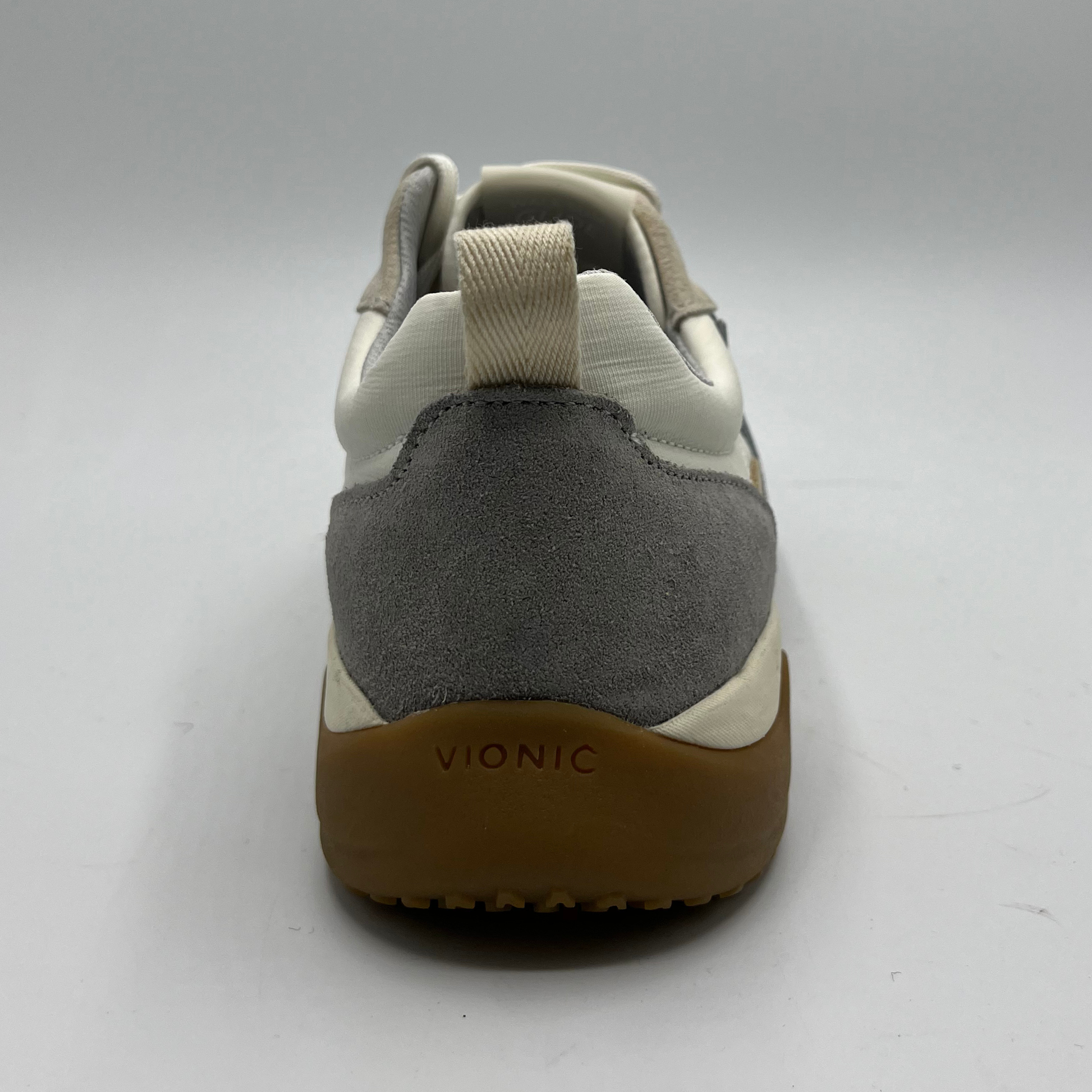 Gray and beige sneaker with brown sole on a white background