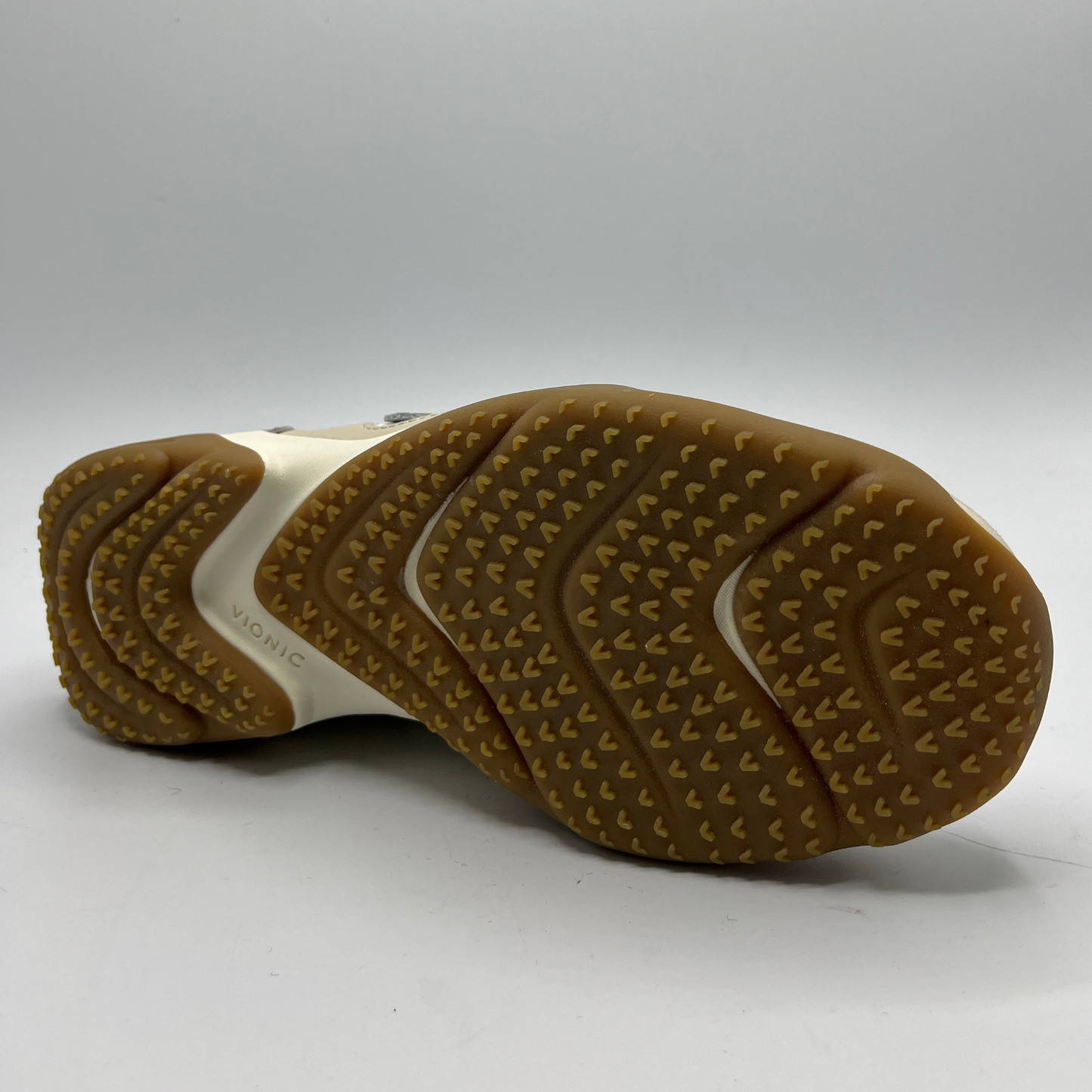 Close-up of a brown shoe sole with tread pattern on a white background