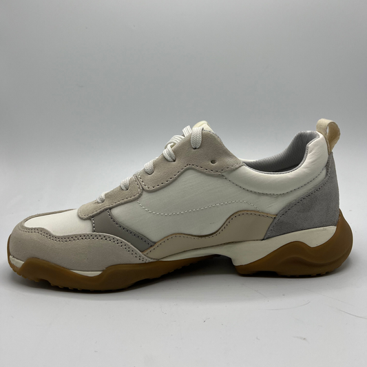 White and gray sneaker with brown sole on a white background