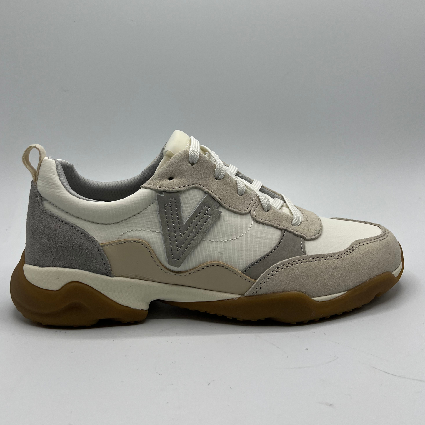 Beige and gray sneaker with brown sole on a white background