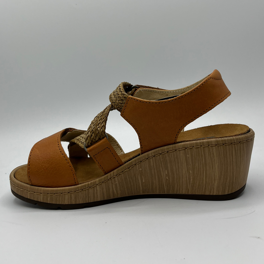 Left facing view of a brown leather sandal with adjustable straps, a contoured footbed and a wedge heel.