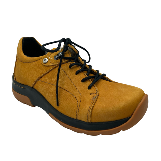 45 degree angled view of nubuck leather sneaker with thick rubber outsole and lace up upper