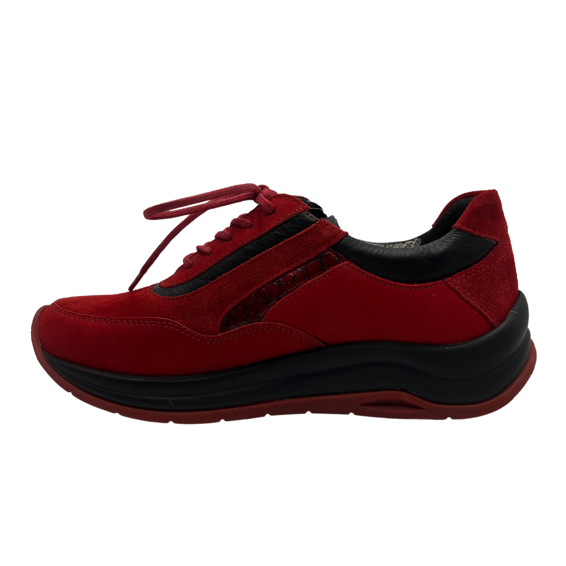 Left facing view of red leather sneakers with a water resistant upper, laces and side zipper closure.