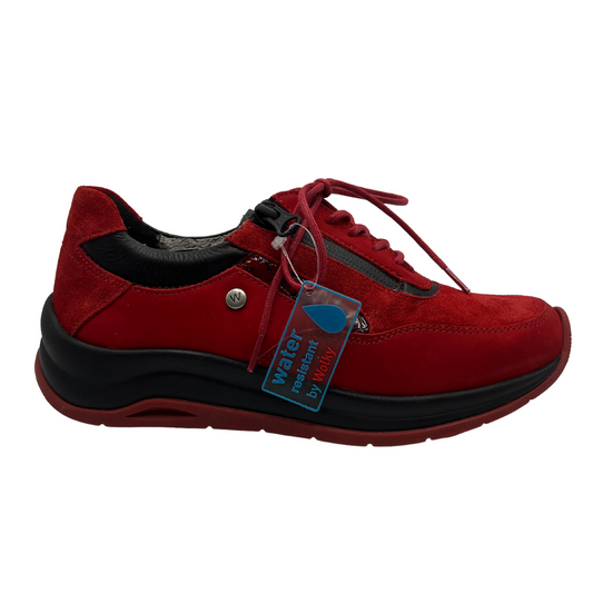 Right facing view of red leather sneakers with a water resistant upper, laces and side zipper closure.