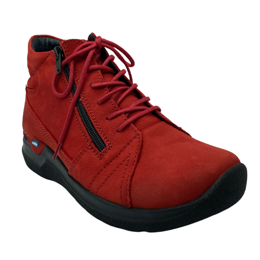 45 degree angled view of red leather walking shoe with red laces and side zipper closure