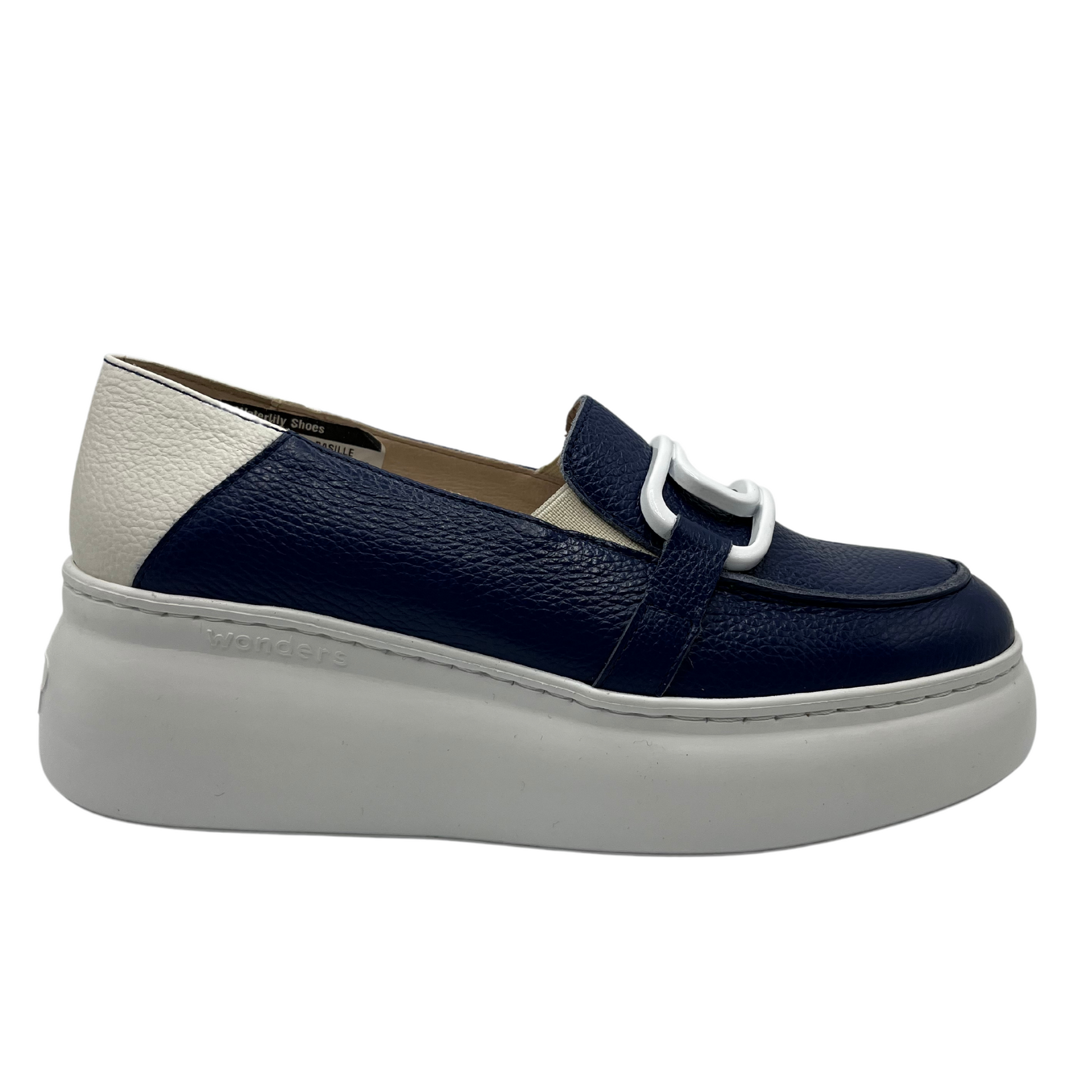 Right facing view of navy and white leather loafer with white rubber platform sole and large white paperclip detail