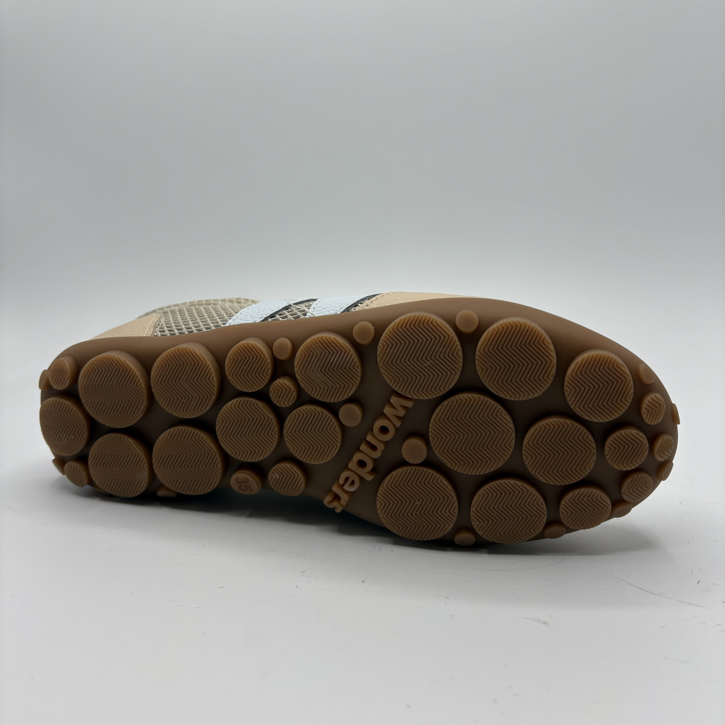 Close-up of a shoe sole with 'Wonders' branding on a white background