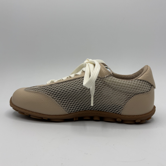 Beige sneaker with white laces on a light gray background