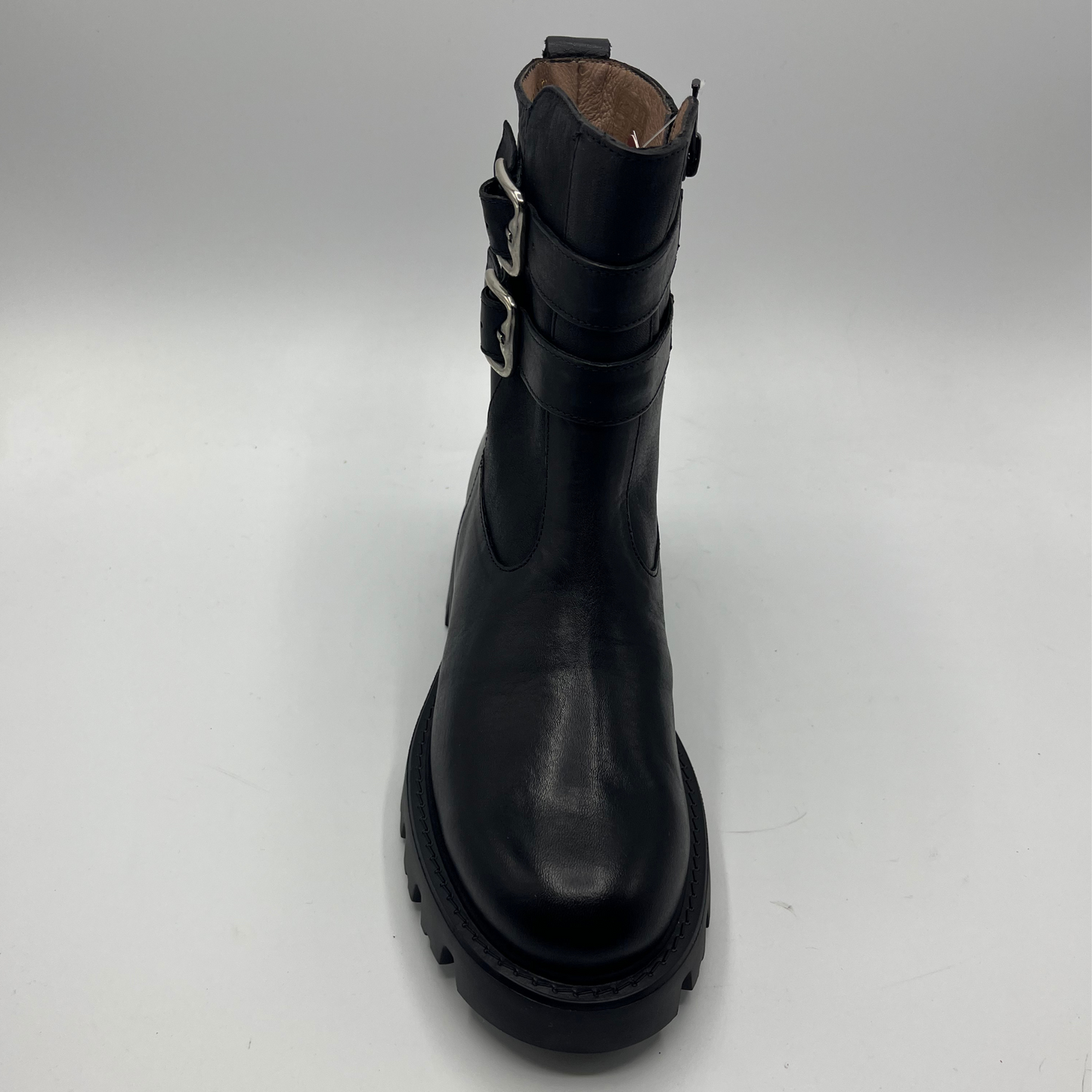 Black boot with metal buckle on a white background
