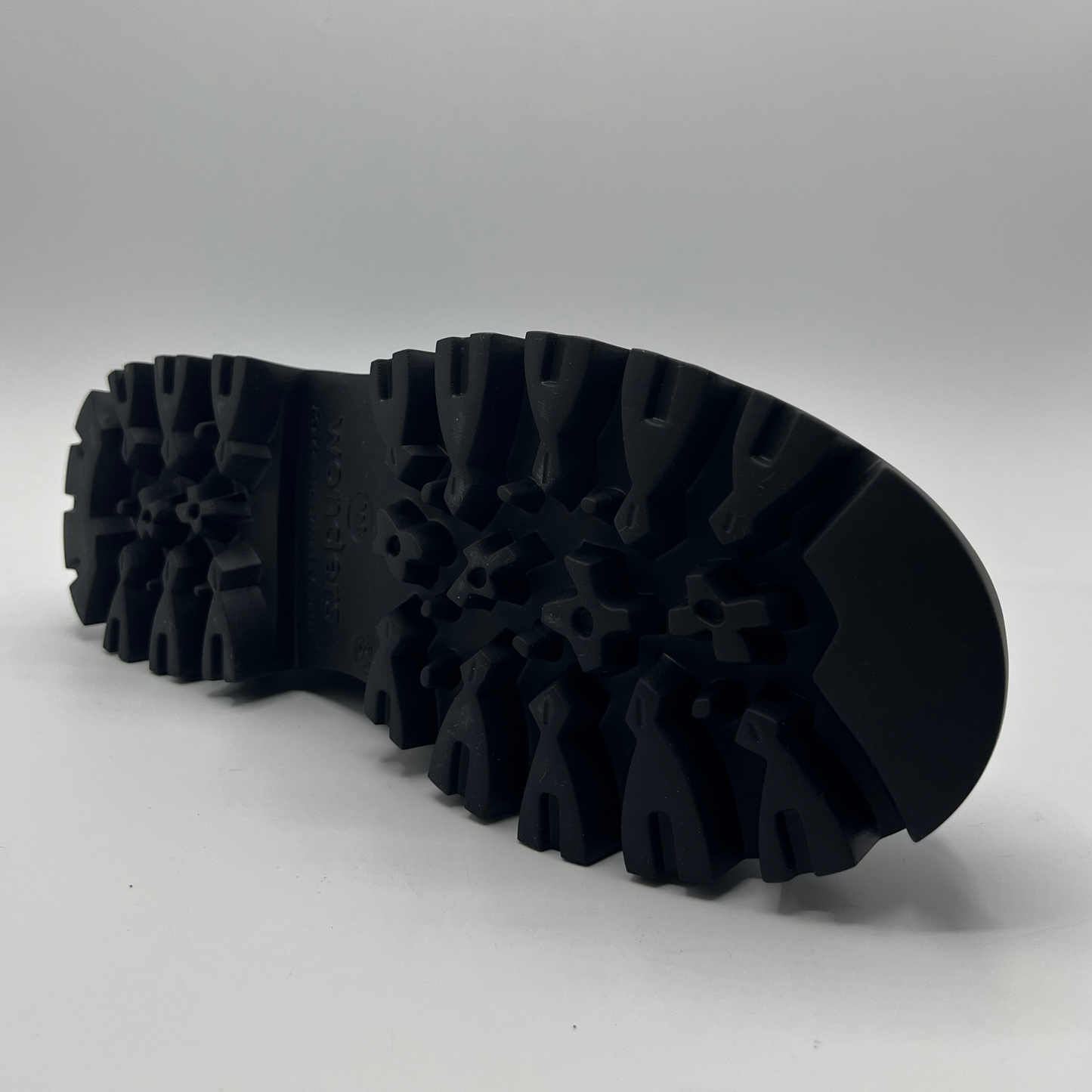 Close-up of a black rubber sole on a white background