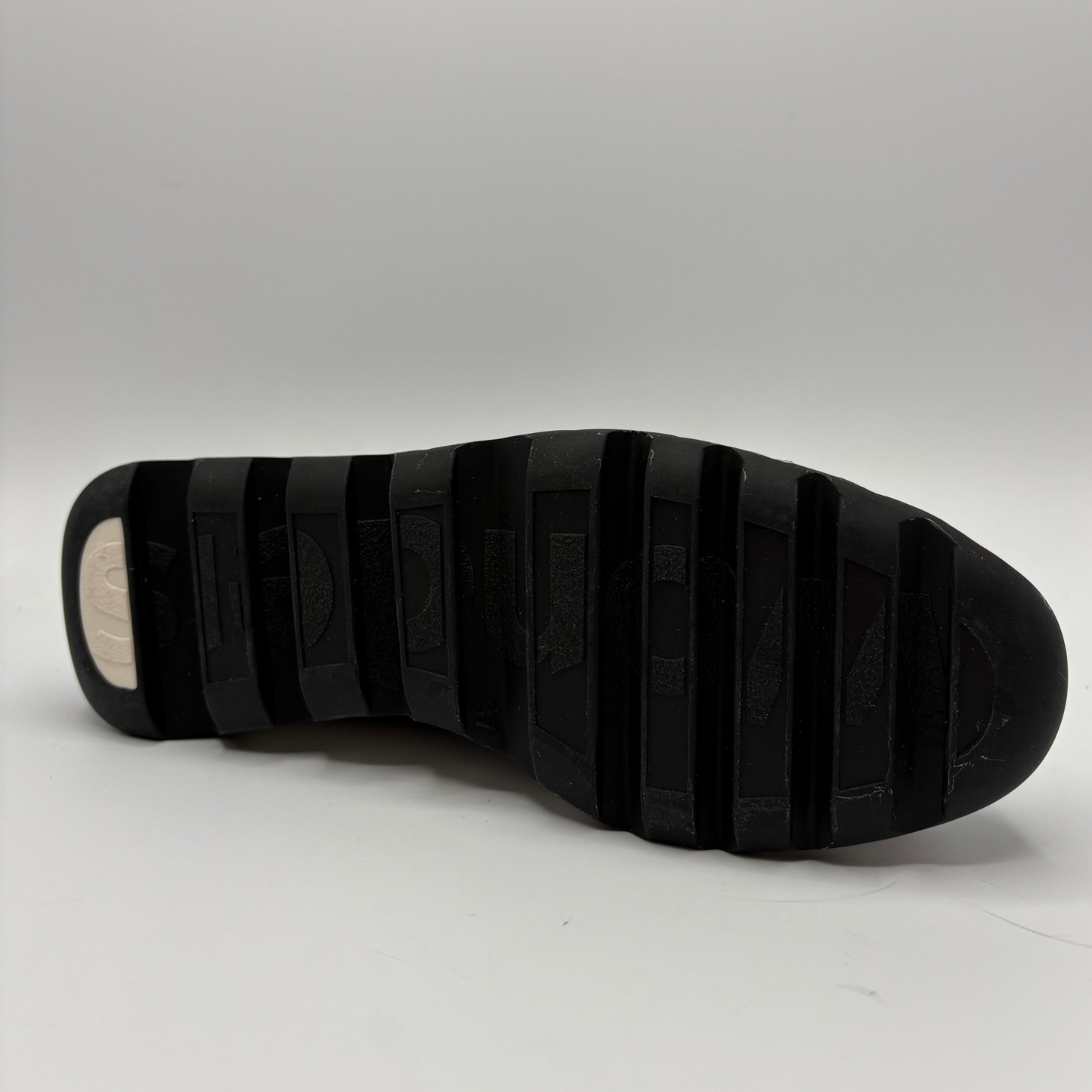 Black sole of a shoe on a white background
