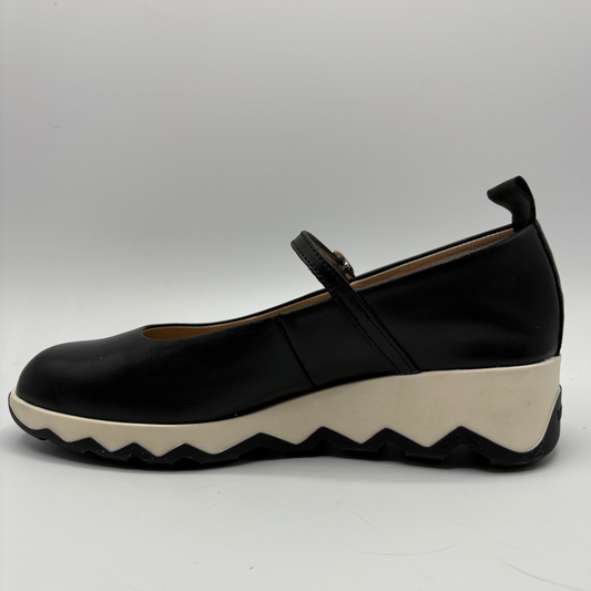 Black shoe with a white sole on a gray background