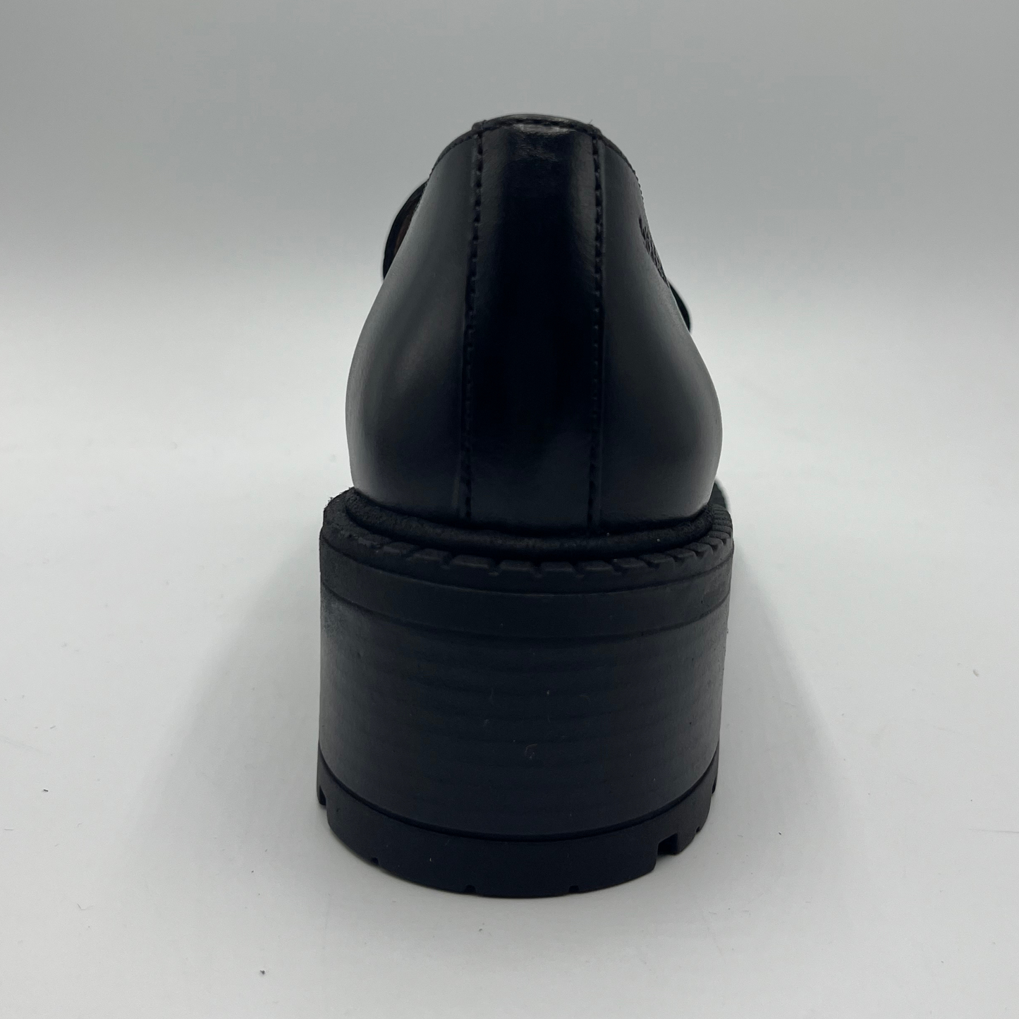 Black leather shoe on a white background