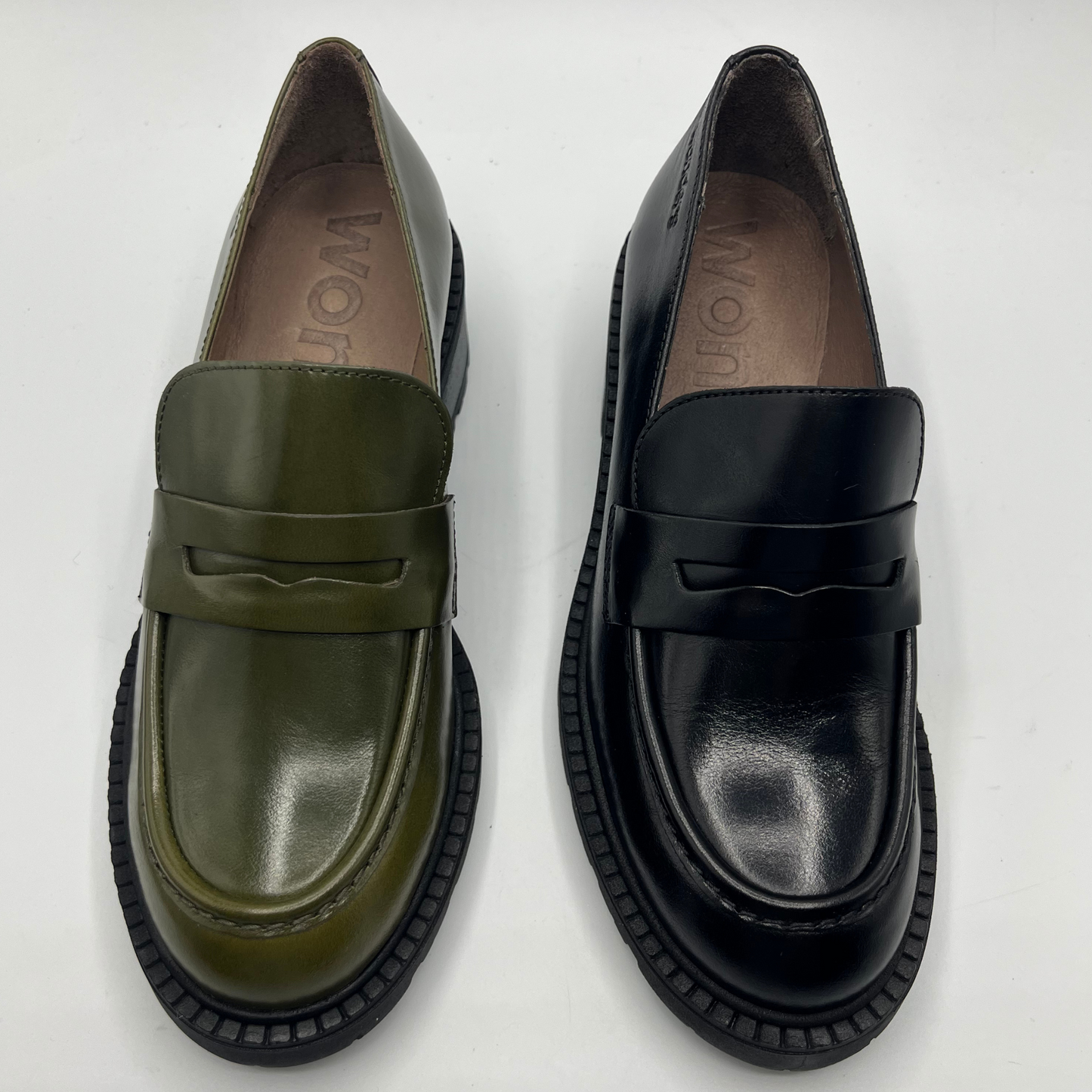 Pair of green and black loafers on a white background