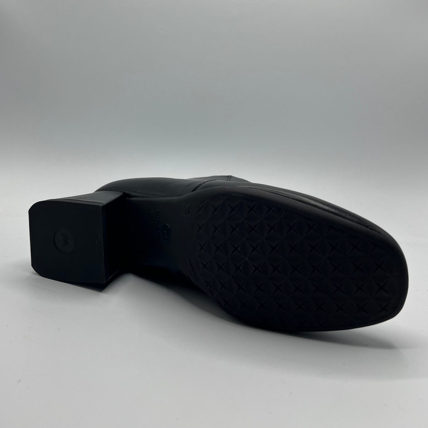 Black shoe sole on a light gray background