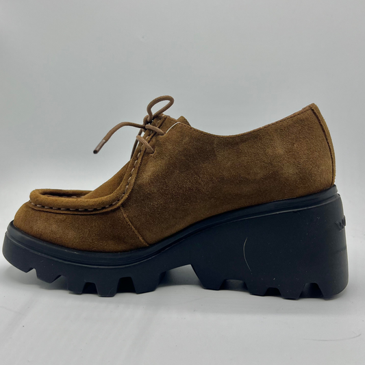 Brown suede shoe with a thick black sole on a light gray background