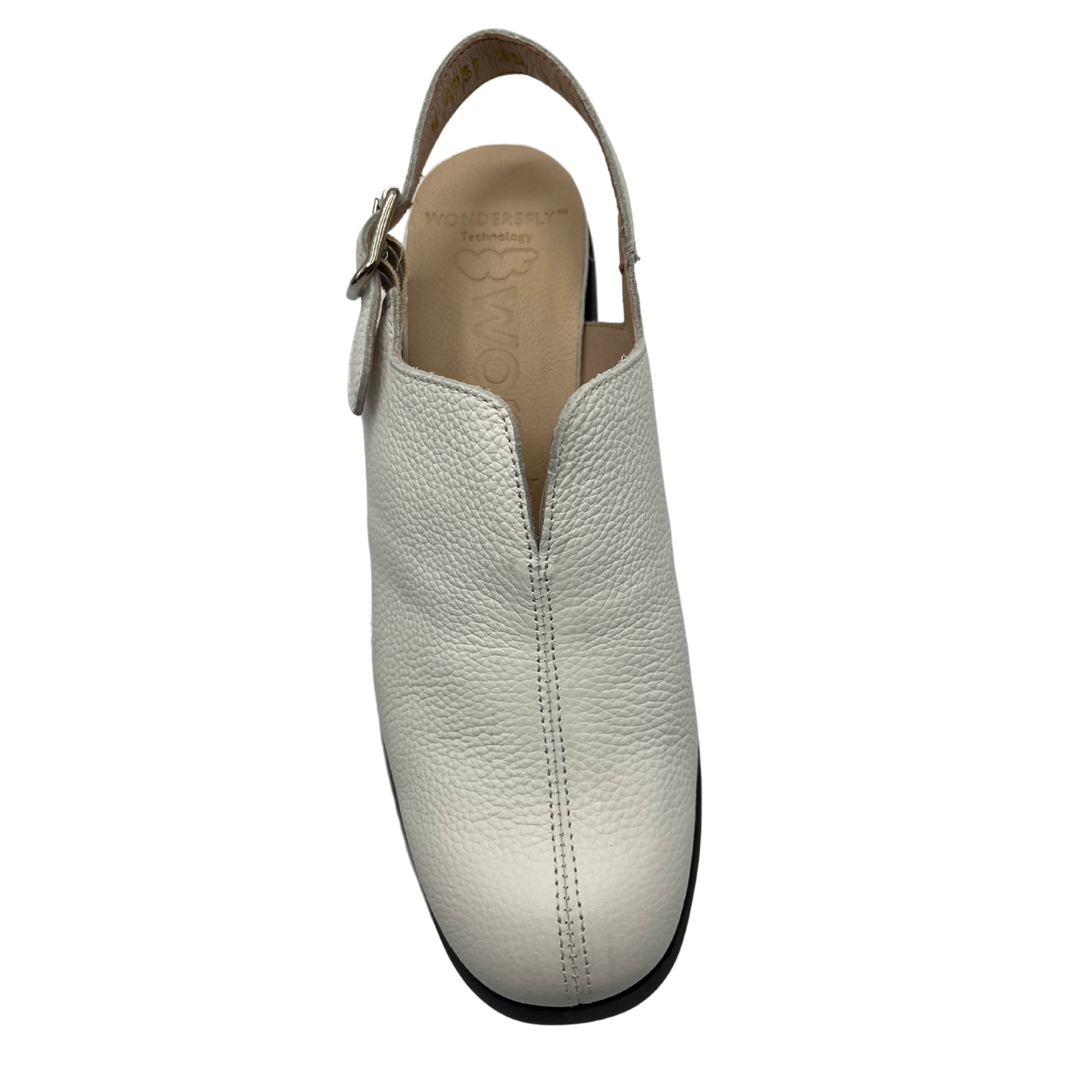Top view of white leather shoe with a sling back strap with a black chunky platform heel and sole