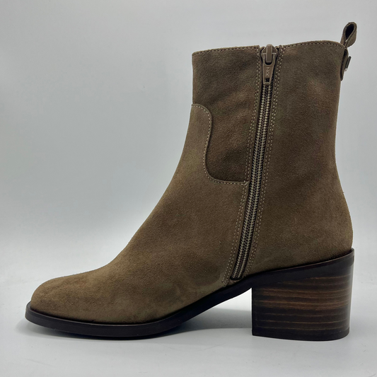 Brown suede ankle boot with a block heel on a gray background