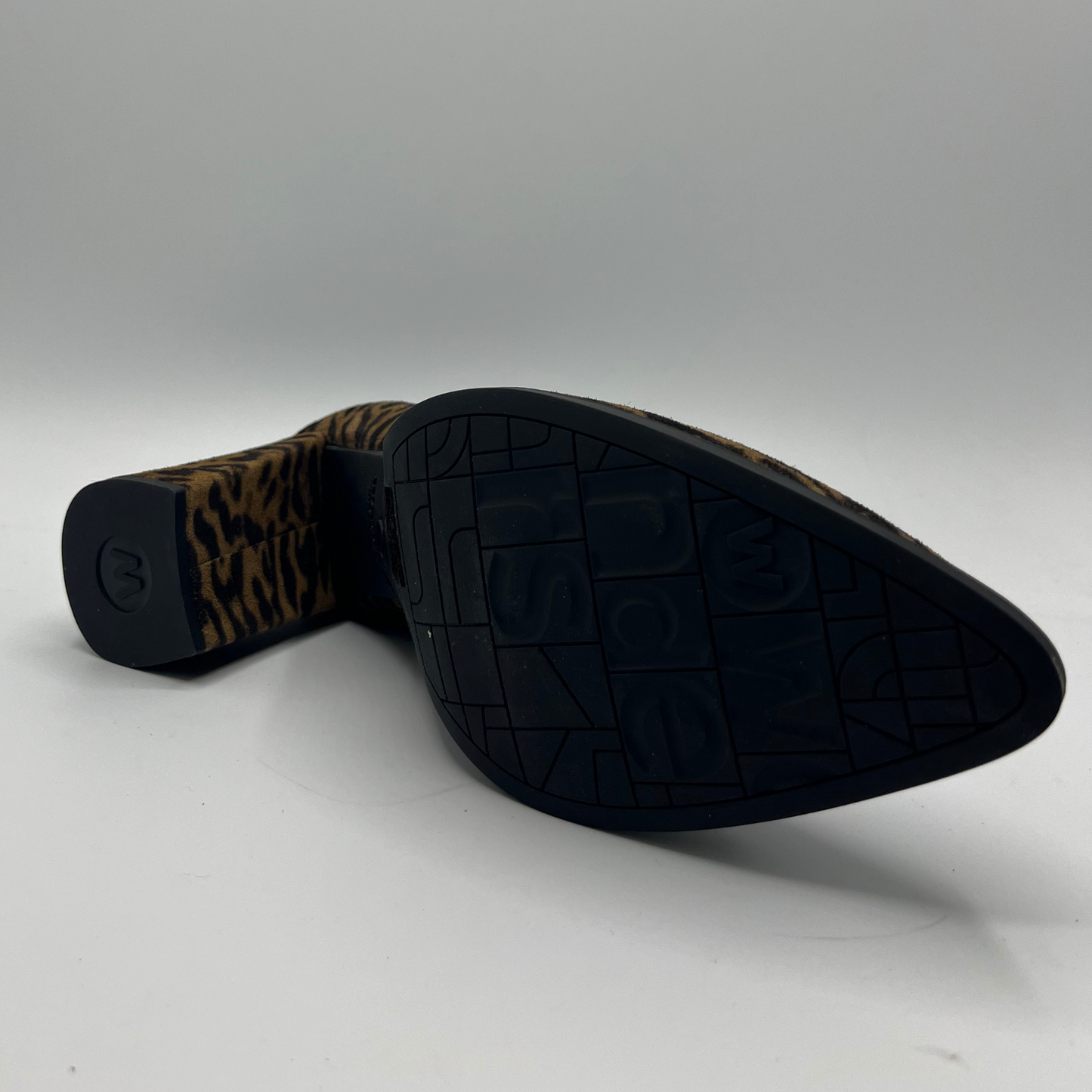 Black shoe sole with leopard print pattern on a gray background