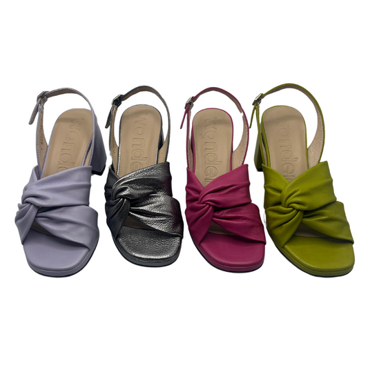 Top view of four leather sandals in a line. Lavender, metallic silver, pink and green apple.