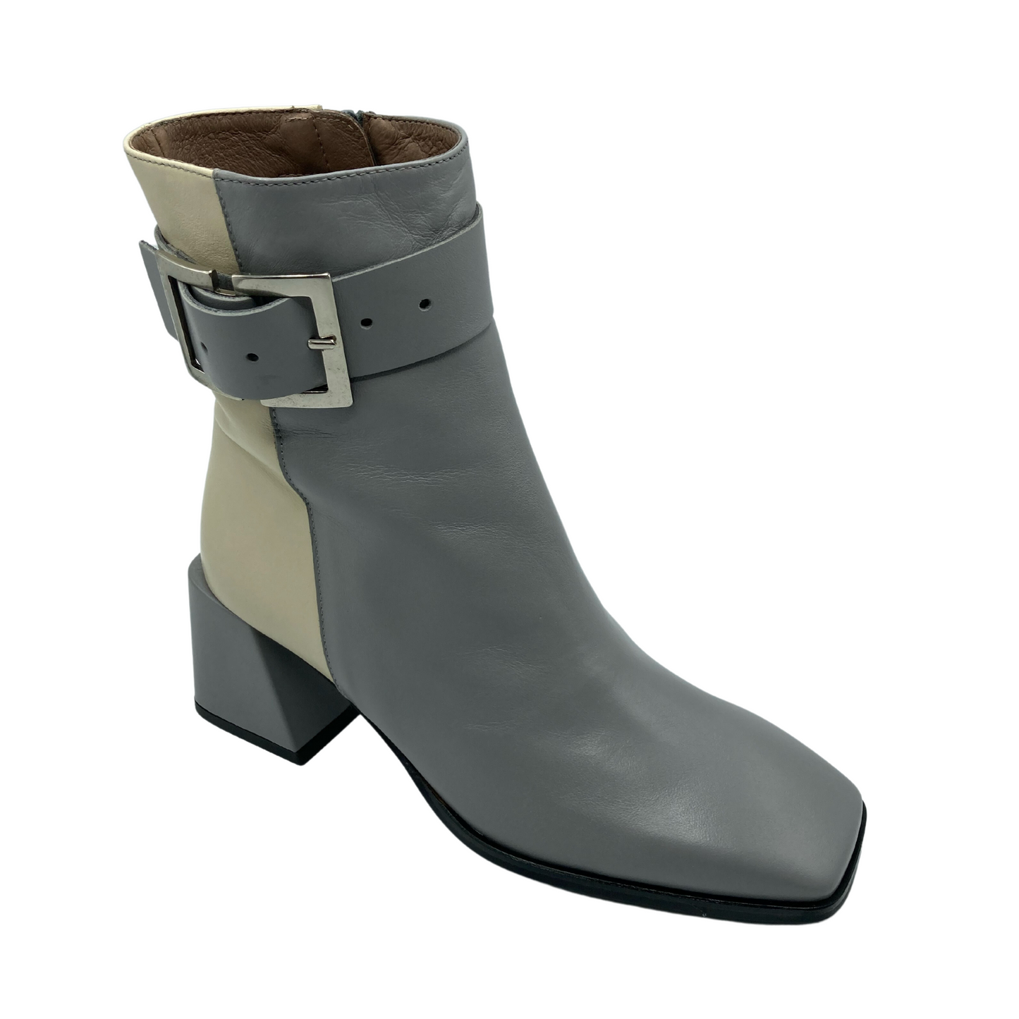 Angled view of grey and cream over the ankle boot with silver buckle on the side