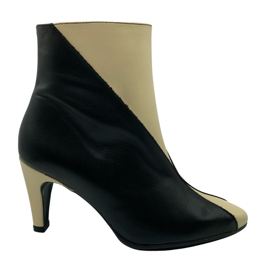 Right facing view of black and cream leather bootie with a kitten heel