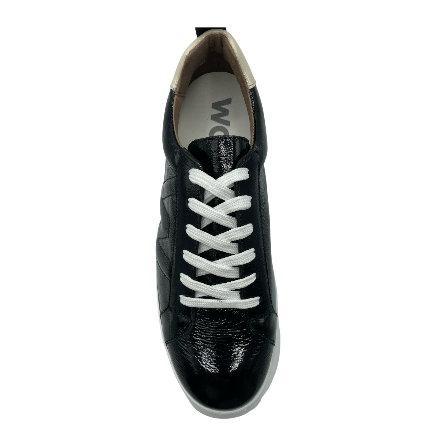 Top view of a black patent sneaker on a white platform sole. The sneaker has white lacing.