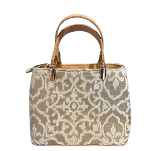 Patterned handbag with brown straps on a white background
