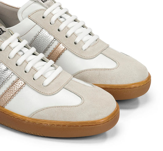 Pair of beige and white sneakers with brown soles on a white background